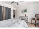 The bedroom features neutral tones, a comfortable queen-sized bed, and a peek into another room at 10852 E Contessa St, Mesa, AZ 85207