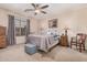 Comfortable bedroom featuring a ceiling fan, neutral paint, and ample natural light through the window at 10852 E Contessa St, Mesa, AZ 85207