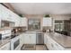 This well-lit kitchen features a stainless steel dishwasher and a backyard view through the window at 10852 E Contessa St, Mesa, AZ 85207