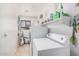 Functional laundry room with white washer and dryer, a window, and shelving at 10852 E Contessa St, Mesa, AZ 85207