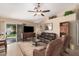 Inviting living room featuring plush seating, a ceiling fan, and seamless access to the backyard through sliding doors at 10852 E Contessa St, Mesa, AZ 85207