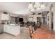 Open-concept living area with tile flooring and vaulted ceilings blends kitchen, dining, and living spaces at 10852 E Contessa St, Mesa, AZ 85207