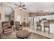 Spacious living area with tile flooring, ceiling fan and seamlessly connecting to the open kitchen and dining areas at 10852 E Contessa St, Mesa, AZ 85207
