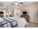 Cozy main bedroom with a comfortable bed, ceiling fan, and neutral walls at 10852 E Contessa St, Mesa, AZ 85207