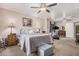 Bright main bedroom with a cozy bed, ceiling fan, an area for exercise, and neutral walls at 10852 E Contessa St, Mesa, AZ 85207