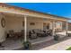 Covered patio with comfortable seating, a table, and decor at 10852 E Contessa St, Mesa, AZ 85207