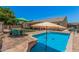 Inviting swimming pool surrounded by a patio and lush landscaping, creating a perfect oasis for relaxation and entertaining at 10852 E Contessa St, Mesa, AZ 85207