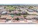 Aerial view of a neighborhood featuring lush green landscaping, swimming pools and beautiful homes at 10943 W Alice Ave, Peoria, AZ 85345