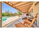 Spacious covered back porch, overlooking the pool area, perfect for lounging and entertaining guests at 10943 W Alice Ave, Peoria, AZ 85345