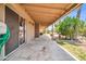 Long covered back porch, offering a cool shaded space with access to the backyard at 10943 W Alice Ave, Peoria, AZ 85345