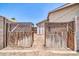 Rustic wooden gate leading to a shed within a fenced-in yard, adding character and privacy at 10943 W Alice Ave, Peoria, AZ 85345