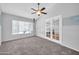Inviting bedroom with carpeted floor, ceiling fan, and double doors leading to another room at 10943 W Alice Ave, Peoria, AZ 85345