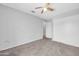 Minimalist bedroom with ceiling fan, carpeted floor, and a large closet at 10943 W Alice Ave, Peoria, AZ 85345