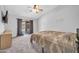 Spacious bedroom with neutral tones, sliding glass door, and ceiling fan at 10943 W Alice Ave, Peoria, AZ 85345