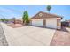 Exterior view featuring a large 2-car garage and well-manicured front yard at 10943 W Alice Ave, Peoria, AZ 85345