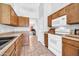 Traditional kitchen has wood cabinets, tile flooring and white appliances at 10943 W Alice Ave, Peoria, AZ 85345