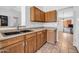 Traditional kitchen features wood cabinets and tile flooring at 10943 W Alice Ave, Peoria, AZ 85345