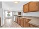 Traditional kitchen with wood cabinetry, tile flooring, and white appliances at 10943 W Alice Ave, Peoria, AZ 85345