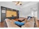 Comfortable living room with large sectional couch and custom built-in shelving at 10943 W Alice Ave, Peoria, AZ 85345