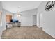 Bright living room featuring tile floors, neutral walls, vaulted ceiling, and a pendant light fixture at 10943 W Alice Ave, Peoria, AZ 85345