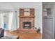 Inviting living room showcasing a traditional brick fireplace and hardwood floors at 10943 W Alice Ave, Peoria, AZ 85345