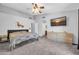 Bright main bedroom with neutral colors, carpet floors, ceiling fan, and a spacious layout at 10943 W Alice Ave, Peoria, AZ 85345