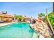 Resort-style pool with a rock waterfall, landscaping, and inviting ambiance at 10943 W Alice Ave, Peoria, AZ 85345