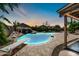 Inviting pool with rock waterfall and diving board for outdoor fun and relaxation at 10943 W Alice Ave, Peoria, AZ 85345