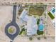 Stunning aerial view of a sprawling estate with lush landscaping, a pool, and a circular driveway at 11250 W Prospector Dr, Queen Creek, AZ 85144