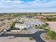 Aerial view of a modern home with desert landscaping, a three-car garage, and a guest house at 11250 W Prospector Dr, Queen Creek, AZ 85144