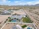 Wide aerial view of a home with a backyard pool and landscaping, with a desert scene beyond at 11250 W Prospector Dr, Queen Creek, AZ 85144