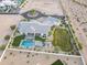 Estate aerial view highlighting the pool, extensive landscaping, patio area, and circular driveway at 11250 W Prospector Dr, Queen Creek, AZ 85144