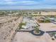 Expansive aerial view of a luxurious property with a pool and circular driveway in a desert landscape at 11250 W Prospector Dr, Queen Creek, AZ 85144