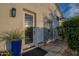 Outdoor patio features a covered shower, door with glass, blue planters, and brick pavers at 11250 W Prospector Dr, Queen Creek, AZ 85144
