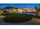 Expansive backyard with lush green grass, modern landscaping, and a beautiful pool with relaxing water features at 11250 W Prospector Dr, Queen Creek, AZ 85144