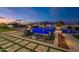 Expansive backyard with a sparkling blue pool, spa, cozy fire pit, and outdoor seating areas for entertaining at 11250 W Prospector Dr, Queen Creek, AZ 85144