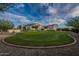 Wide shot of the expansive backyard with green lawn, desert landscaping, and a view of the home at 11250 W Prospector Dr, Queen Creek, AZ 85144