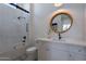 Elegant bathroom featuring tub and shower, white vanity with marble countertop and wood-trimmed mirror at 11250 W Prospector Dr, Queen Creek, AZ 85144