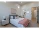 Bright bedroom featuring neutral colors, ample natural light, and an ensuite bathroom at 11250 W Prospector Dr, Queen Creek, AZ 85144