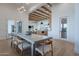 Open-concept dining room with wood floors, concrete table, and view to the kitchen and living area, great for entertaining at 11250 W Prospector Dr, Queen Creek, AZ 85144