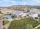 Beautiful home with a well-manicured lawn, desert landscaping, a pool, and mountain views in the distance at 11250 W Prospector Dr, Queen Creek, AZ 85144