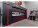 Well-organized garage with black cabinets with red trim, workbench, and tool storage, perfect for DIY projects at 11250 W Prospector Dr, Queen Creek, AZ 85144