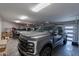 Spacious garage features a new pickup truck with work truck and ample room for parking and storage at 11250 W Prospector Dr, Queen Creek, AZ 85144