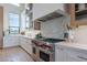 Modern kitchen with marble countertops, high-end appliances, and stylish cabinetry, offering a sophisticated cooking experience at 11250 W Prospector Dr, Queen Creek, AZ 85144