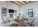 Bright living room with wooden beams, modern fireplace, and comfortable seating arrangement at 11250 W Prospector Dr, Queen Creek, AZ 85144
