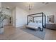Spacious main bedroom featuring a four-poster bed, neutral color palette, and hardwood floors at 11250 W Prospector Dr, Queen Creek, AZ 85144