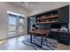 Bright office with built-in cabinetry, desk space, and a beautiful view through French doors at 11250 W Prospector Dr, Queen Creek, AZ 85144