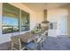 An outdoor kitchen and dining area is visible from inside through an oversized window at 11250 W Prospector Dr, Queen Creek, AZ 85144