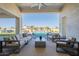 Covered outdoor living space features comfortable seating with backyard views of pool and desert landscaping at 11250 W Prospector Dr, Queen Creek, AZ 85144