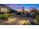 Comfortable outdoor seating area with cozy couches and manicured desert landscaping under a colorful twilight sky at 11250 W Prospector Dr, Queen Creek, AZ 85144